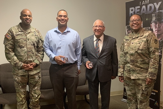 COL Ericka Brooks ’00, CDR USAISEC accompanied by CSM Endesha Johnson, presenting coins for outstanding performance to LTC (R) Agustin (‘Gus’) Ortiz ’76 and LTC (R) Anthony Shepard ’95 at Fort Belvoir, Virginia.